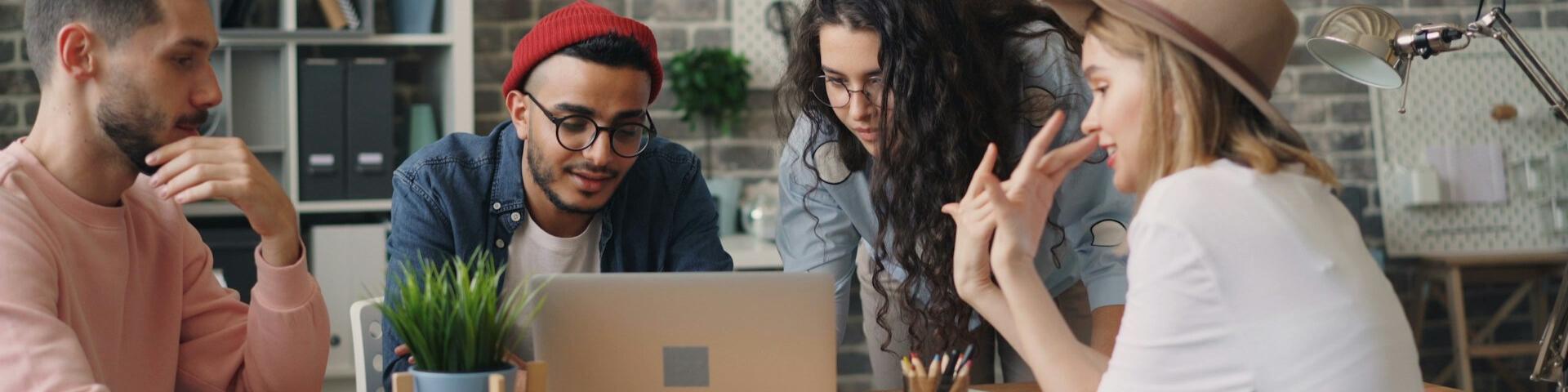 Group of people looking at a laptop